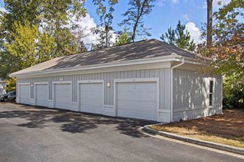 a large white garage with a garage door on the side of it